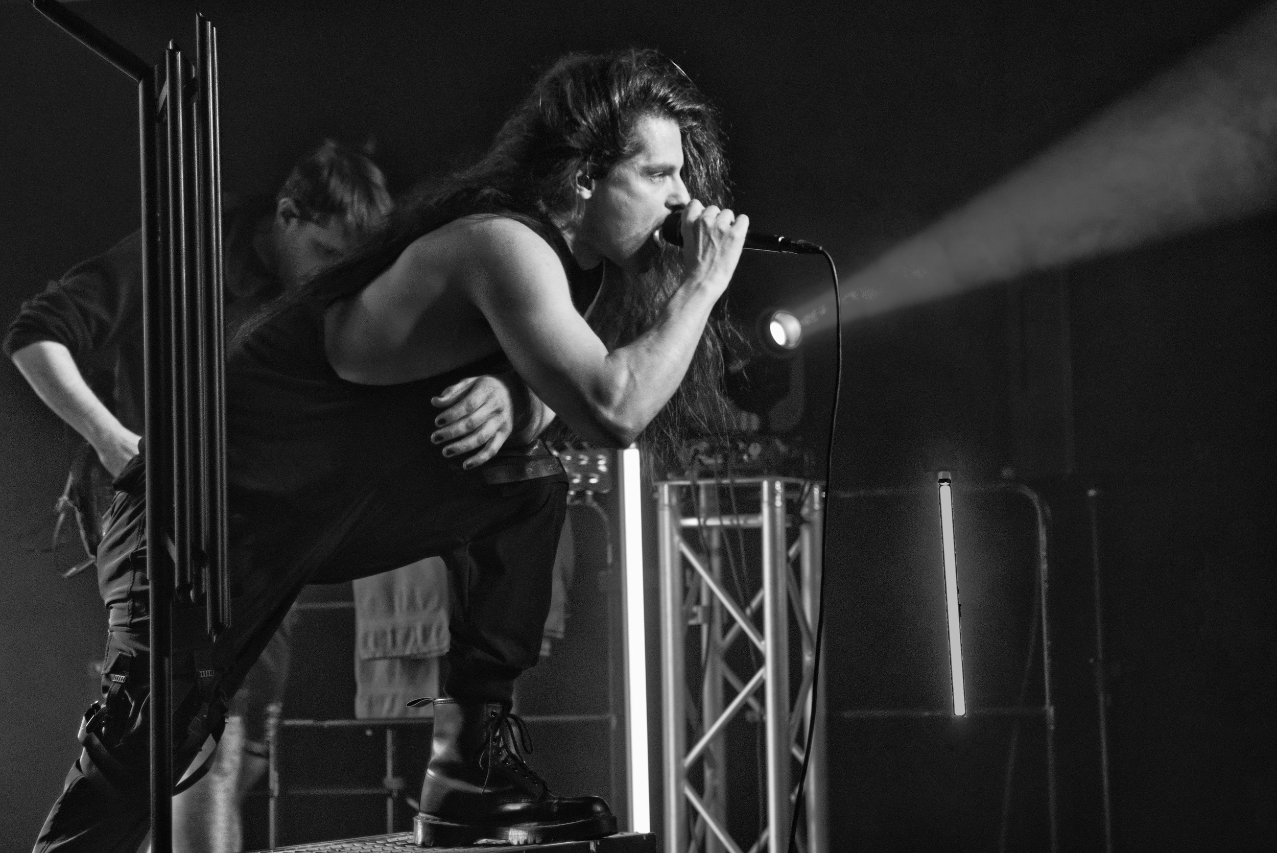Peter performing vocals in a black-and-white close-up live photo