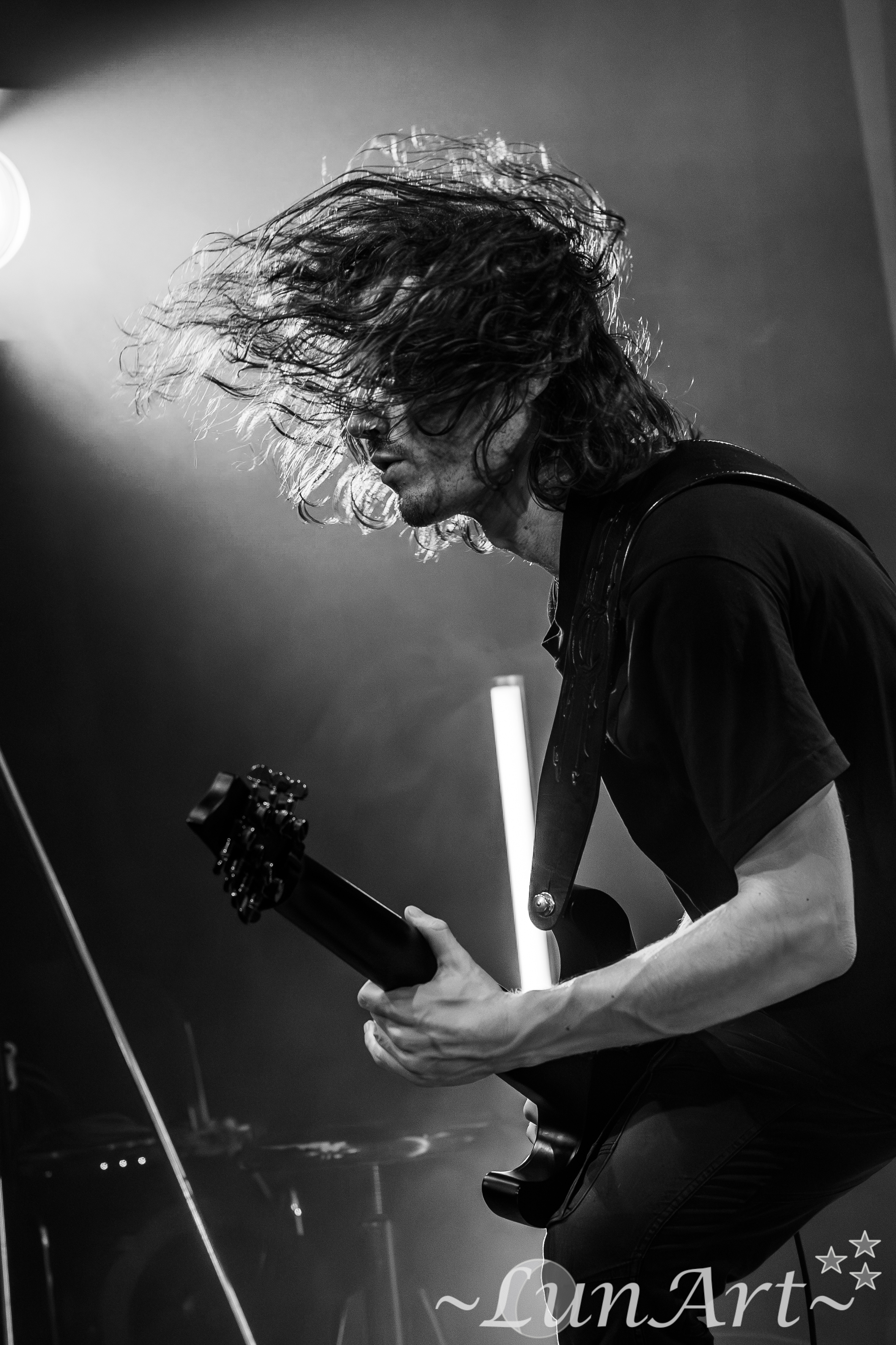 Guitarist headbanging in a high-energy black-and-white motion shot